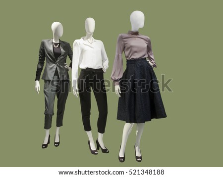 Three female mannequins dressed with fashionable modern clothes, isolated. No brand names or copyright objects. Royalty-Free Stock Photo #521348188