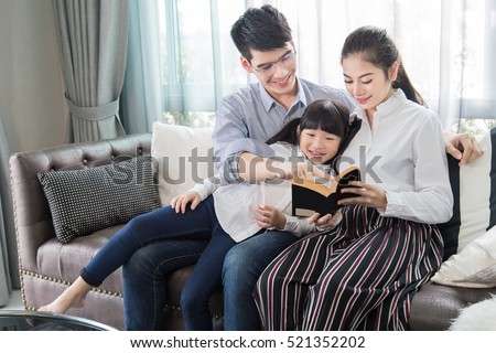 Father and mother Teaching children to do their homework at home,Asian family is happy