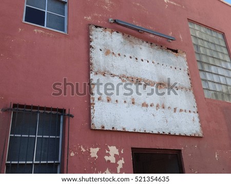 Facade of a commercial building with empty sign above the entrance