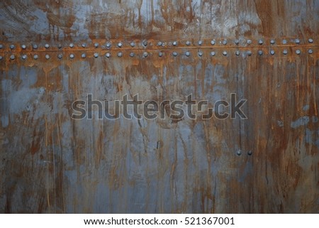 texture of rusty metal with rivets Royalty-Free Stock Photo #521367001