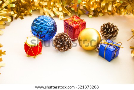 Christmas ornament composition on white background. Blue and golden fir tree balls. Red blue Christmas presents. Natural pine cone. Red Chinese drum. Decor objects for Christmas or Chinese New Year