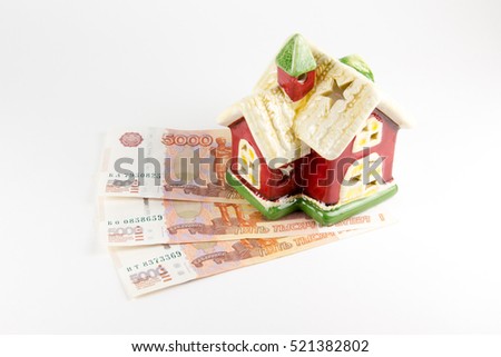 House and money on a white background