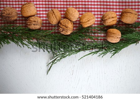 Christmas checkered fabric background with juniper and nuts