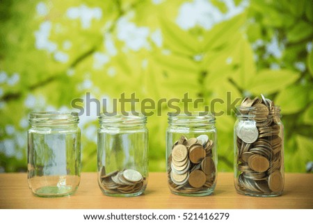 saving glass jar on green natural leaves background