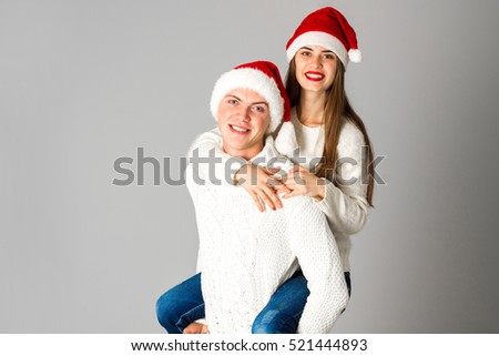 couple in love celebrates christmas in santa hat