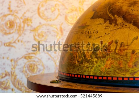 Photo of an old retro globe on brown background