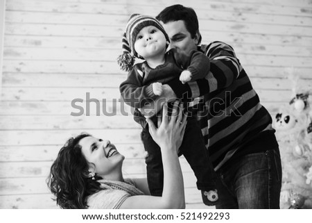 young and happy parents with their cute little boy playing together
