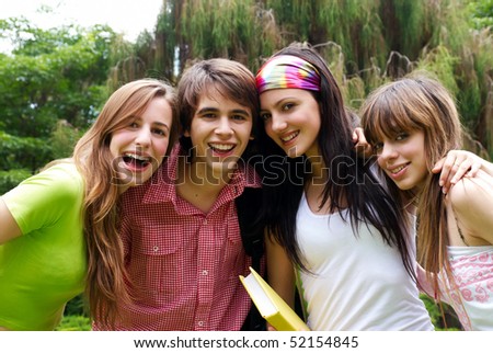  Portrait happy young students in park Royalty-Free Stock Photo #52154845