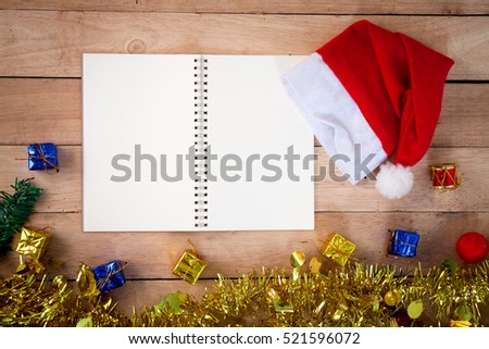Christmas and Happy new year with a Christmas ball, gift, red hat on a wooden. holiday background

