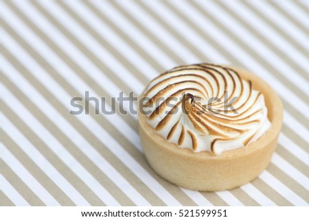 Lemon mini tart on a textured paper
