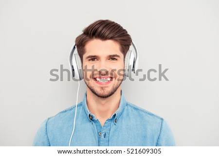 Cheerful relaxed music lover listening music in headphones
