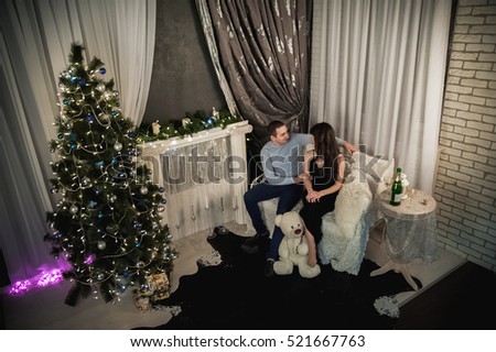 Beautiful couple at Christmas. Lovely couple on the background of the Christmas tree for the New Year