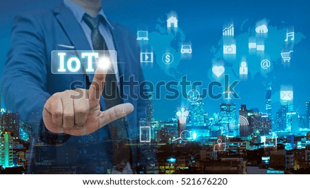 Double exposure of business man touch on virtual screen with night modern city building background , internet of things concept