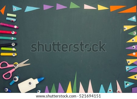 school background for art and craft class with objects laid on the surface of the blackboard