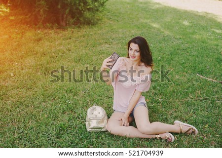 Girl does a make-up, walks in the park and photographed