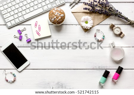 female wooden desktop with smartphone and flowers top view