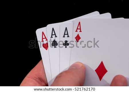 four aces in hand on black