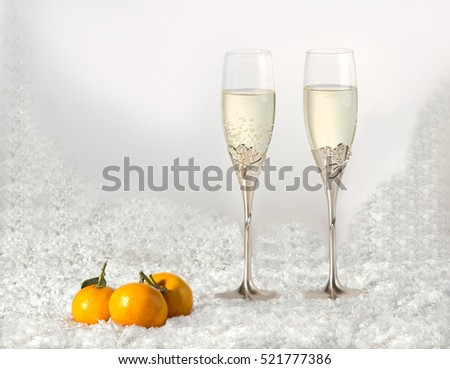 Happy new year, backgrounds.\ Glasses with champagne, tangerines, snow backgrounds.