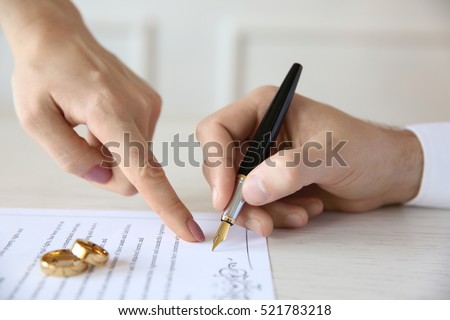 Man signing marriage contract, closeup Royalty-Free Stock Photo #521783218
