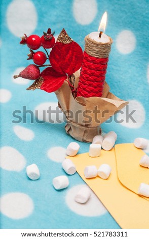 on a blue background red candle marshmallow on the envelope