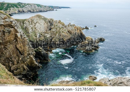 Rocky sea cliffs, Brittany, France. coastal points flora,mysterious landscapes Royalty-Free Stock Photo #521785807