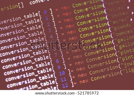 Code language of conversion table on a computer screen with a shallow depth of field. Image taken in an angle and has a strong vintage effect.