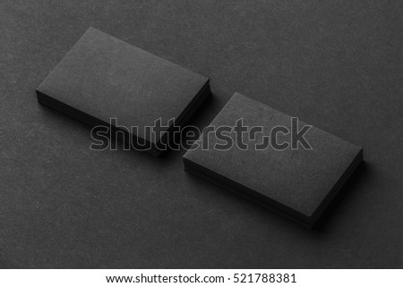 Mockup of two blank business cards stacks at black textured background. Royalty-Free Stock Photo #521788381