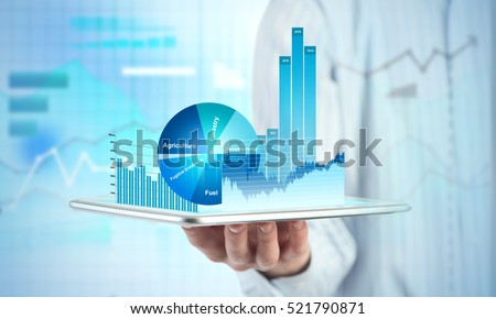 Close view of businessman with tablet and graphs and charts on screen Royalty-Free Stock Photo #521790871