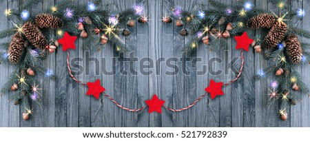 Christmas background with illumination, glowing stars, spruce branches, pine cones, acorns. Winter holidays concept. 