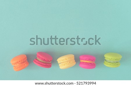 Colorful macaroons on blue background, fade as vintage tone
