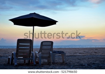 Umbrellas, deck chairs on the beach with a beautiful sky in the evening.