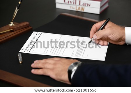 Man signing power of attorney, closeup