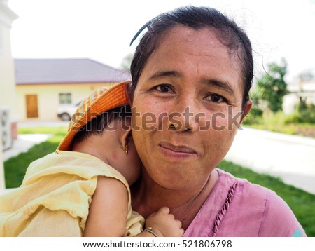 Mother carrying her child in her arms,Mother love her daughter,mother copy space,Myanmar people