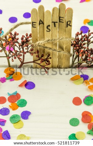 the word Easter in the conceptual block text on wooden sticks, a fun colored background