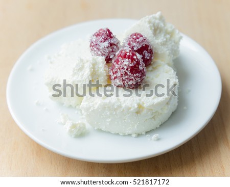 Cottage cheese in plate with berries