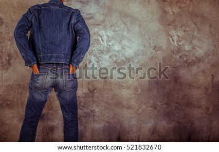 Young man Denim blue jean jacket. Background wall. for design denim fashion. Retro style