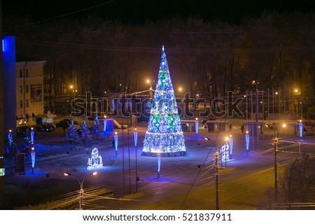 New Year and Christmas tree on square in Arkhangelsk, december night. High iso grained picture.