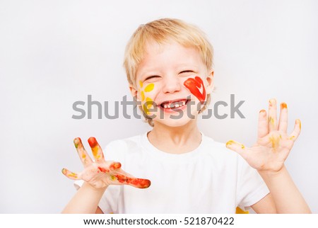 Portrait of laughing beautiful child with hands in paint. Close up of cheerful funny small boy isolated on white background. Blond baby going to make handprints. Horizontal color photography