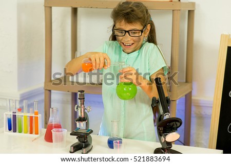 young girl making science experiments in laboratory. education