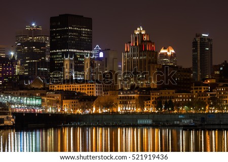Historical Old Montreal skyline on a summer night seen from the Ste-Lawrence river, Canada