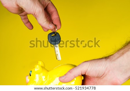 Key in hand and piggy