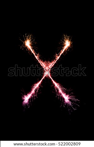X,English alphabet from sparkler on black background,Alphabet big letter
