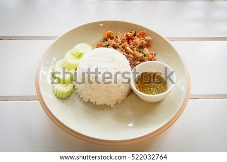 Close up Rice topped with stir fried minced pork on plate