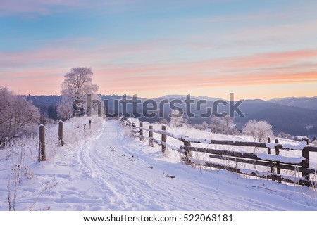 Fantastic evening winter landscape. Dramatic overcast sky. Creative collage. Beauty world. Royalty-Free Stock Photo #522063181