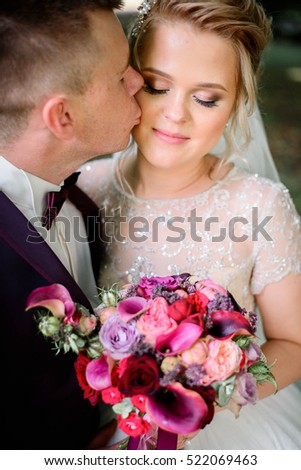 nice portrait of beautiful and young bride and groom outdoors