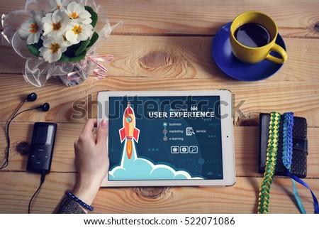 Laptop computer, tablet pc and User experience concept on wooden office desk with copy space. Design concept background with rocket. 