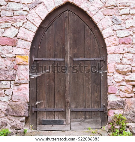 Old stone wall and old brown boards wooden door. Castle Strahlenberg, Schriesheim, Baden-Wuerttemberg, Germany