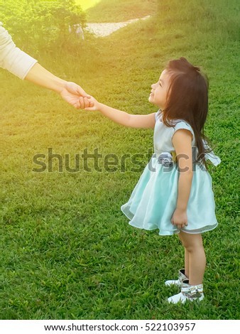 Daddy holding pretty daughter's hand.Love and family concept.