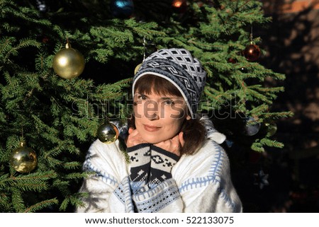 Woman sitting near the Christmas tree