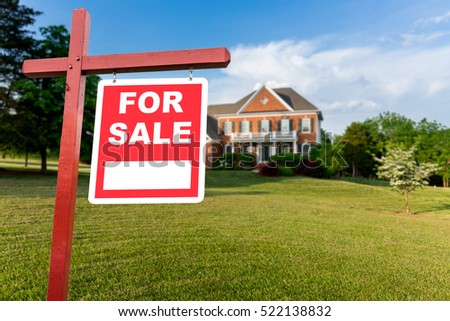 For Sale realtor sign in front of large brick single family house in expansive grass yard for real estate opportunity